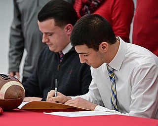 STRUTHERS, OHIO - FEBRUARY 1, 2017: A.J. Musolino, right, of Struthers signs his national letter of intent to play football at Kent State University, Wednesday afternoon at Struthers High School. DAVID DERMER | THE VINDICATOR