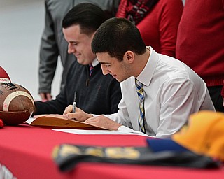 STRUTHERS, OHIO - FEBRUARY 1, 2017: A.J. Musolino, right, of Struthers signs his national letter of intent to play football at Kent State University, Wednesday afternoon at Struthers High School. DAVID DERMER | THE VINDICATOR