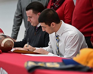 STRUTHERS, OHIO - FEBRUARY 1, 2017: A.J. Musolino, right, of Struthers signs his national letter of intent to play football at Kent State University, Wednesday afternoon at Struthers High School. DAVID DERMER | THE VINDICATOR