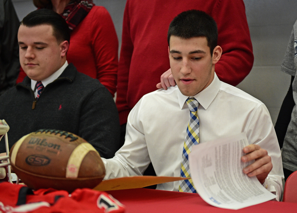 STRUTHERS, OHIO - FEBRUARY 1, 2017: A.J. Musolino, right, of Struthers signs his national letter of intent to play football at Kent State University, Wednesday afternoon at Struthers High School. DAVID DERMER | THE VINDICATOR