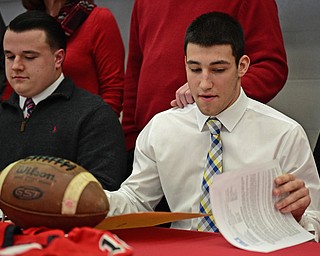 STRUTHERS, OHIO - FEBRUARY 1, 2017: A.J. Musolino, right, of Struthers signs his national letter of intent to play football at Kent State University, Wednesday afternoon at Struthers High School. DAVID DERMER | THE VINDICATOR