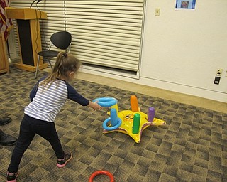 Neighbors | Alexis Bartolomucci.One of the children played a ring toss game on Jan. 19 at the Austintown library Celebrate Summer program.