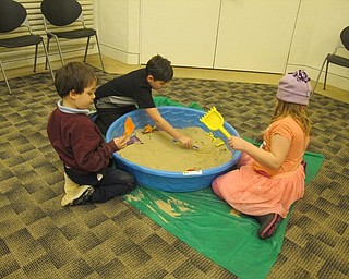 Neighbors | Alexis Bartolomucci.Children dug in the sandbox looking for different items during the Celebrate Summer program at the Austintown library on Jan. 19.