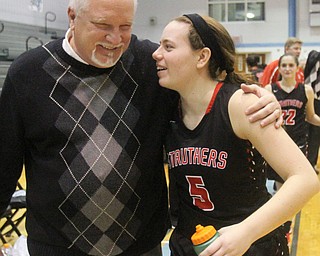William D. Lewis The Vindicator  Struthers girls basketball coach John Grandy gets a hug from Karli Shives(5) after his team beat East for Grandy's 200th win.