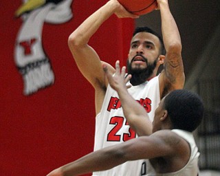 William D. Lewis The Vindicator  YWSU Francisco Santiago (23) shoots over Oakland's Brailen Neely(11) during Feb 2, 2017 action at YSU.