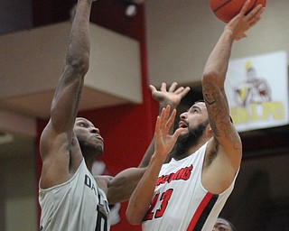 William D. Lewis The Vindicator  YSU Francisco Santiago(23) shoots over Oakland's Isiah Brock(10) during Feb 2, 2017 action at YSU.