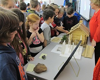 Neighbors | Alexis Bartolomucci.Laurie Fox from the Poland Township Historical Society talked to the Dobbins Elementary students as they look at different artifacts on Jan. 23.
