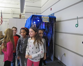 Neighbors | Alexis Bartolomucci.Third-grade students walk in the room through the Poland Time Tunnel at Dobbins Elementary on Jan. 23 as they prepare to learn about the history of Poland.