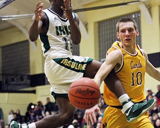 William D. Lewis The Vindicator Mooney's Pat Pelini(10) blocks a shot by  Ursuline's Dakota Hobbs(14) during 2/3/17 action at Ursuline  Please check spelling. Scorers handwriting was nearly unreadable.