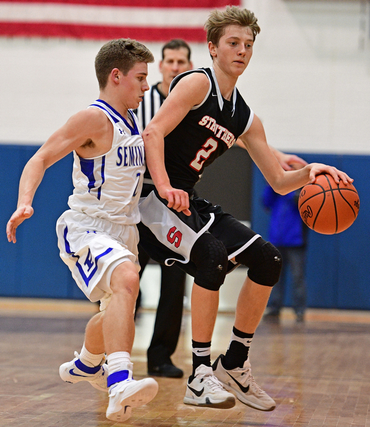 POLAND, OHIO - FEBRUARY 3, 2017: Carson Ryan #2 of Struthers attempts to dribble up court while being pressured by Mike Diaz #2 of Poland during the first half of their game Friday night at Poland High School. DAVID DERMER | THE VINDICATOR