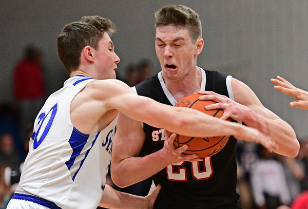POLAND, OHIO - FEBRUARY 3, 2017: Ryan Leonard #20 of Struthers protects the ball while Kyle Patterson #30 of Poland during the first half of their game Friday night at Poland High School. DAVID DERMER | THE VINDICATOR