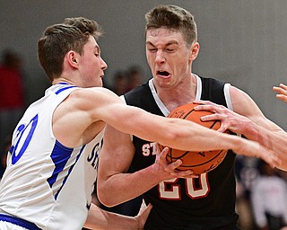 POLAND, OHIO - FEBRUARY 3, 2017: Ryan Leonard #20 of Struthers protects the ball while Kyle Patterson #30 of Poland during the first half of their game Friday night at Poland High School. DAVID DERMER | THE VINDICATOR