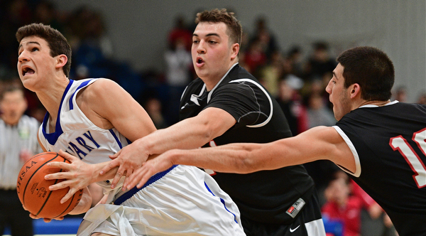 POLAND, OHIO - FEBRUARY 3, 2017: Braeden O'Shaungnessy #3 of Poland goes to the basket while Jaret Jacubec #24 and AJ Musolino #10 of Struthers reach for the ball during the second half of their game Friday night at Poland High School. DAVID DERMER | THE VINDICATOR