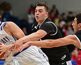 POLAND, OHIO - FEBRUARY 3, 2017: Braeden O'Shaungnessy #3 of Poland goes to the basket while Jaret Jacubec #24 and AJ Musolino #10 of Struthers reach for the ball during the second half of their game Friday night at Poland High School. DAVID DERMER | THE VINDICATOR