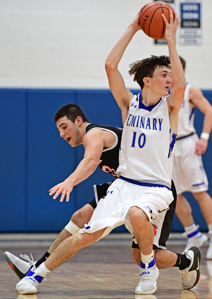 POLAND, OHIO - FEBRUARY 3, 2017: Daniel Kramer #10 of Poland protects the ball from the reach of AJ Musolino #10 of Struthers during the second half of their game Friday night at Poland High School. DAVID DERMER | THE VINDICATOR