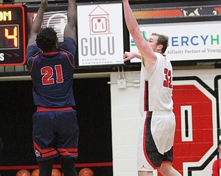 Detroit Mercy junior forward Joleel Hogan(21) goes up for three as Youngstown State Penguins senior center Jorden Kaufman(32) attempts to block the shot during the first half as Detroit Mercy University takes on Youngstown State at the Beeghly Center at Youngstown State University in Youngstown on Saturday, Feb. 4, 2017. Detroit Mercy won, 90-80...(Nikos Frazier | The Vindicator)..