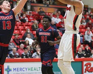 Youngstown State Penguins junior guard Francisco Santiago(23) goes up for two as Detroit Mercy freshman forward Cole Long(13) attempts to block the shot during the first half as Detroit Mercy University takes on Youngstown State at the Beeghly Center at Youngstown State University in Youngstown on Saturday, Feb. 4, 2017. Detroit Mercy won, 90-80...(Nikos Frazier | The Vindicator)..