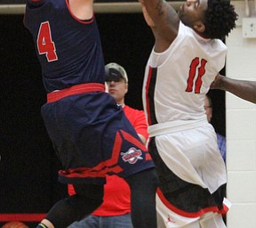 Detroit Mercy junior guard DeShawndre Black(4) goes up towards the net as Youngstown State Penguins sophomore guard Latin Davis(11) attempts to block during the first half as Detroit Mercy University takes on Youngstown State at the Beeghly Center at Youngstown State University in Youngstown on Saturday, Feb. 4, 2017. Detroit Mercy won, 90-80...(Nikos Frazier | The Vindicator)..