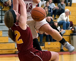 MICHAEL G TAYLOR | THE VINDICATOR- 02-04-17 -Basketball-  1st qtr., as she drives to the hoop, Columbiana's #13 Marian Rovnak  looses control of the ball against Mooney's #14 Camden Hergenrother  and #12 Taylor Martin.  Lady Basketball- Cardinal Mooney vs Columbiana Clippers at Columbiana High School in Richard Berryman Gymnasium, Columbiana,, OH