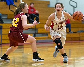MICHAEL G TAYLOR | THE VINDICATOR- 02-04-17 -Basketball-  1st qtr., Columbiana's #13 Marian Rovnak  drives to the hoop against Mooney's #32 Caitlyn Sapp.  Lady Basketball- Cardinal Mooney vs Columbiana Clippers at Columbiana High School in Richard Berryman Gymnasium, Columbiana, OH