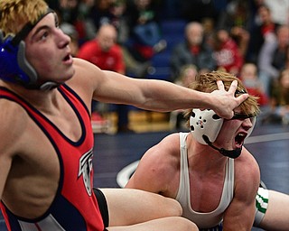 AUSTINTOWN, OHIO - FEBRYARY 4, 2017: Cameron Martig of West Branch has his eye poked by AJ Stehura of Fitch as he falls to the mat during their 152lb championship bout Saturday night at Austintown Fitch High School. DAVID DERMER | THE VINDICATOR
