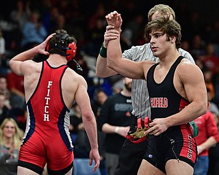AUSTINTOWN, OHIO - FEBRYARY 4, 2017: Georgio Poullas of Canfield has his arm raised by the referee after defeating Michael Ferree of Fitch during their 160lb championship bout Saturday night at Austintown Fitch High School. DAVID DERMER | THE VINDICATOR