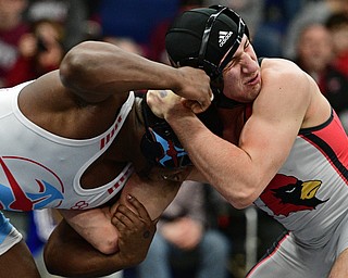 AUSTINTOWN, OHIO - FEBRYARY 4, 2017: Dominic Cooper of Canfield braces for a charge from Duce Johnson of Alliance during their 182lb championship bout Saturday night at Austintown Fitch High School. DAVID DERMER | THE VINDICATOR