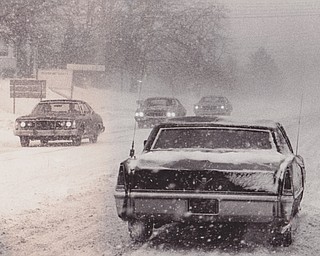 Locally, motorists returning home Friday after early business and industry closings found traffic at a near standstill for about an hour as high winds and blowing snow made visibility almost zero. THis scene on Belmont Ave was common in the area.