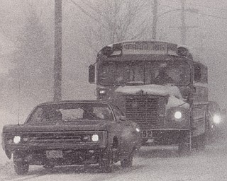School buses throughout the area were on the road by noon as schools and businesses closed early. This school bus, spotted on Coitsville Road, found the roadways slippery with driving conditions described as "hazardous." Most area school children were safe at home by early afternoon.