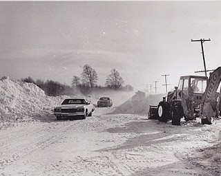 2Snow as high as an elephant's eye -- snow drifts reached heights of 12 to 14 feet along State Route 193 near the Youngstown Municipal Airport north of the city over the weekend and plows from the J.S. Durig Construction Co., Warren, were called into service to maintain traffic. The Ohio State Highway Patrol limited traffic to one lane at times using their police ratios to control traffic flow past the airport.