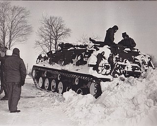 Balky Tank Retriever -- Crewmen work on the Ohio National Guard's big M88 Tank Retriever, disabled with a frozen battery. The big vehicle, brought to Salem from Ravenna, was to have cleared snow-closed roads in the Salem area. The monster's failure to start disappointed newspeople on hand for the run.