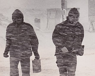 Weather was enough -- As if the extremely low temperatures and blowing snow weren't enough for any man, the fates added an empty fuel tank to the hardship of these two men, spotted Friday on Route 422, near Route 616. Their dark figures, conspicuous against the blowing snow in this picture, were almost impossible to see for some motorists, whose visibility was reduced to zero by the blizzard.