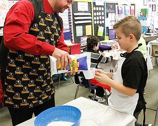        ROBERT K. YOSAY  | THE VINDICATOR..Gavin English wih his dad (supervisor)  Ken  carefully measure sugar together ..Hot Chocolate production in Kristin Hartshorn 3rd grade class - was at peak production on thursday afternoon as packets of Hot Chocolate .  starting with ingredients and ending up in take home bags at a buck and a half ...-30-.