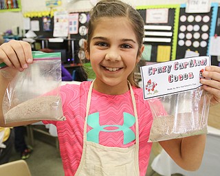        ROBERT K. YOSAY  | THE VINDICATOR..ready for sale as  Sofia Castronova shows off the packets of chocolate ..Hot Chocolate production in Kristin Hartshorn 3rd grade class - was at peak production on thursday afternoon as packets of Hot Chocolate .  starting with ingredients and ending up in take home bags at a buck and a half ...-30-.
