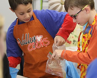       ROBERT K. YOSAY  | THE VINDICATOR..Joey Beshara and Evan Linko fill a bag with the delicious hot chocolate..Hot Chocolate production in Kristin Hartshorn 3rd grade class - was at peak production on thursday afternoon as packets of Hot Chocolate .  starting with ingredients and ending up in take home bags at a buck and a half ...-30-.