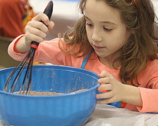        ROBERT K. YOSAY  | THE VINDICATOR..Elise Kovach mixes up the ingredients before packaging..Hot Chocolate production in Kristin Hartshorn 3rd grade class - was at peak production on thursday afternoon as packets of Hot Chocolate .  starting with ingredients and ending up in take home bags at a buck and a half ...-30-.