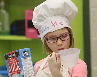        ROBERT K. YOSAY  | THE VINDICATOR...Kailyn Halchuck (ok) checks the measurement on a cup ..Hot Chocolate production in Kristin Hartshorn 3rd grade class - was at peak production on thursday afternoon as packets of Hot Chocolate .  starting with ingredients and ending up in take home bags at a buck and a half ...-30-.