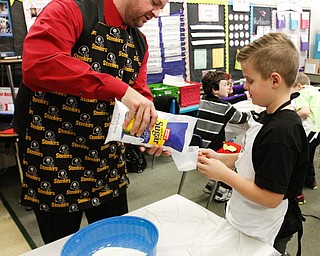        ROBERT K. YOSAY  | THE VINDICATOR..Gavin English wih his dad (supervisor)  Ken  carefully measure sugar together ..Hot Chocolate production in Kristin Hartshorn 3rd grade class - was at peak production on thursday afternoon as packets of Hot Chocolate .  starting with ingredients and ending up in take home bags at a buck and a half ...-30-.
