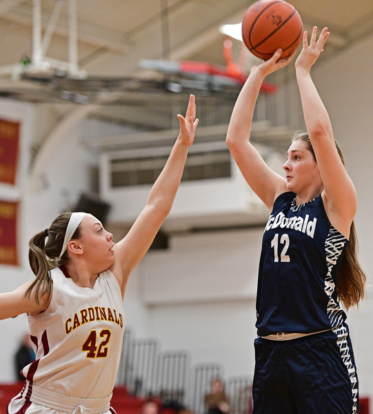 YOUNGSTOWN, OHIO - FEBRUARY 6, 2017: Sam Homa #12 of McDonald puts up a shot over Concetta Rinaldi #42 of Mooney during the first half of their game Monday night at Cardinal Mooney High School. DAVID DERMER | THE VINDICATOR
