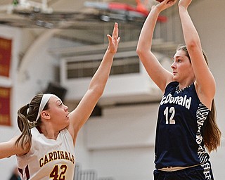 YOUNGSTOWN, OHIO - FEBRUARY 6, 2017: Sam Homa #12 of McDonald puts up a shot over Concetta Rinaldi #42 of Mooney during the first half of their game Monday night at Cardinal Mooney High School. DAVID DERMER | THE VINDICATOR