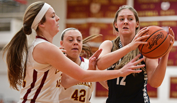 YOUNGSTOWN, OHIO - FEBRUARY 6, 2017: Sam Homa #12 of McDonald looks to pass the ball while being pressured by Taylor Martin #12 and Concetta Rinaldi #42 of Mooney during the first half of their game Monday night at Cardinal Mooney High School. DAVID DERMER | THE VINDICATOR