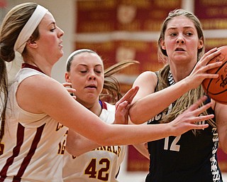 YOUNGSTOWN, OHIO - FEBRUARY 6, 2017: Sam Homa #12 of McDonald looks to pass the ball while being pressured by Taylor Martin #12 and Concetta Rinaldi #42 of Mooney during the first half of their game Monday night at Cardinal Mooney High School. DAVID DERMER | THE VINDICATOR