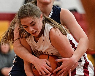 YOUNGSTOWN, OHIO - FEBRUARY 6, 2017: Camden Hergencothen #14 of Mooney secures the ball while being fouled by Sam Homa #12 of McDonald after blocking her shot during the first half of their game Monday night at Cardinal Mooney High School. DAVID DERMER | THE VINDICATOR