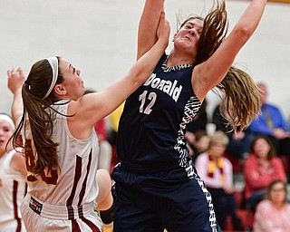 YOUNGSTOWN, OHIO - FEBRUARY 6, 2017: Sam Homa #12 of McDonald grabs a rebound by Concetta Rinaldi #42 of Mooney during the first half of their game Monday night at Cardinal Mooney High School. DAVID DERMER | THE VINDICATOR