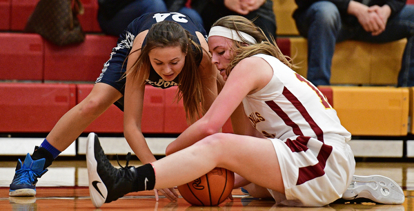 YOUNGSTOWN, OHIO - FEBRUARY 6, 2017: Britney Smith #24 of McDonald and Taylor Martin #12 of Mooney battle for a loss ball on the floor during the first half of their game Monday night at Cardinal Mooney High School. DAVID DERMER | THE VINDICATOR