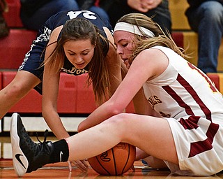 YOUNGSTOWN, OHIO - FEBRUARY 6, 2017: Britney Smith #24 of McDonald and Taylor Martin #12 of Mooney battle for a loss ball on the floor during the first half of their game Monday night at Cardinal Mooney High School. DAVID DERMER | THE VINDICATOR