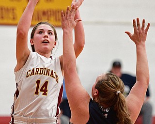 YOUNGSTOWN, OHIO - FEBRUARY 6, 2017: Camden Hergencothen #14 of Mooney puts up a shot over Hannah Donkers #30 of McDonald during the first half of their game Monday night at Cardinal Mooney High School. DAVID DERMER | THE VINDICATOR