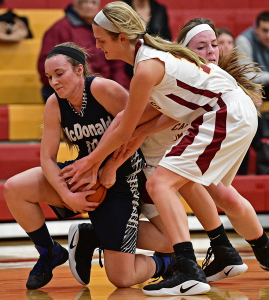 YOUNGSTOWN, OHIO - FEBRUARY 6, 2017: Kendra Kelly #10 of McDonald battles for the ball on the floor with Lauren Fommelt #15 and Taylor Martin #12 of Mooney during the first half of their game Monday night at Cardinal Mooney High School. DAVID DERMER | THE VINDICATOR