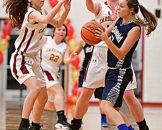 YOUNGSTOWN, OHIO - FEBRUARY 6, 2017: Britney Smith #24 of McDonald looks to pass the ball after being trapped by Concetta Rinaldi #42 and Carolyn Kay #10 of Mooney during the first half of their game Monday night at Cardinal Mooney High School. DAVID DERMER | THE VINDICATOR