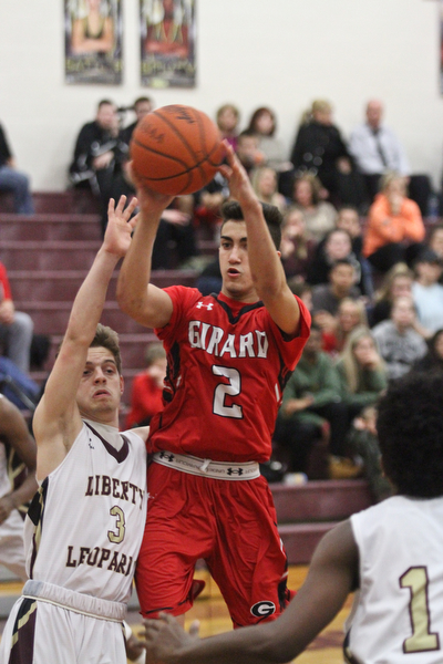 William D. Lewis The vindicator  Girard's Austin Claussell(2) shoots over Liberty's Kevin Hawn(3) during February 7, 2017 action at Liberty.